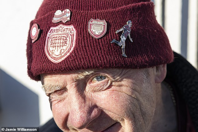 Arbroath fan Paddy Evans proudly displays the club's crest on his woollen hat