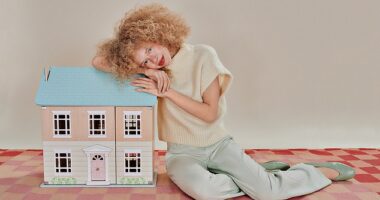Jumper, Mint Velvet. Trousers, Malina. Shoes, Dune London. Doll’s house, John Lewis. Rug, Floor Story.