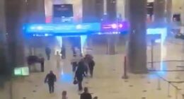 Dramatic footage shows passengers at Dubai's primary international airport fleeing the airport following reports of a strike on one of its terminals
