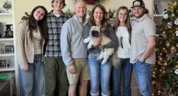 Melissa Graham, seen with her family, is being sued for allegedly embezzling hundreds of thousands of dollars from her former employer