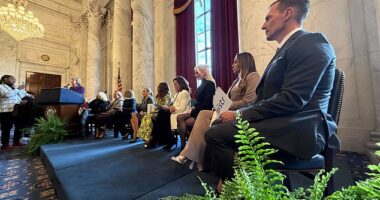 Housewives cast members from various franchises listen to Wisconsin Democrat Senator Tammy Baldwin speak
