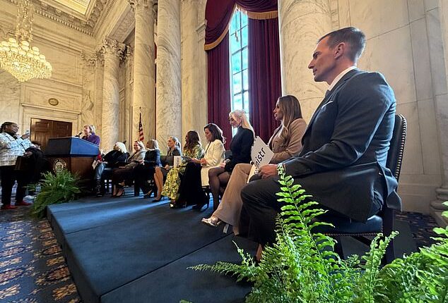 Housewives cast members from various franchises listen to Wisconsin Democrat Senator Tammy Baldwin speak