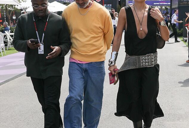 Rita Ora (right) has been making the most of her glamorous visit Down Under. The UK pop star stepped out at the Australian Grand Prix on Sunday, and had her husband Taika Waititi (centre) on her arm