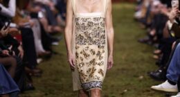 Gillian Anderson walked the moss-covered Miu Miu catwalk in a gold sequin-embellished square-neck shift dress and high heels