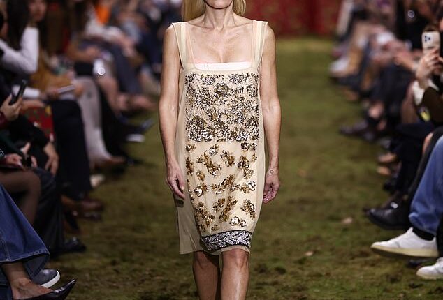 Gillian Anderson walked the moss-covered Miu Miu catwalk in a gold sequin-embellished square-neck shift dress and high heels