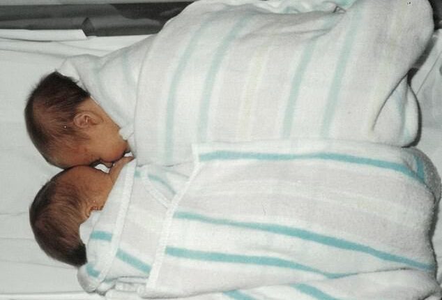 Sasha and her twin sister (above) were implanted in the wrong mother as IVF embryos