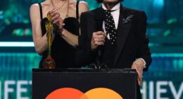 Sharon and Kelly Osbourne make heartfelt speech in honour of Ozzy while Dolly Parton and Robbie Williams pay 'fitting tribute' to the late rocker as he's awarded Lifetime Achievement Award at the BRITs