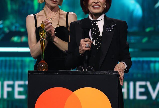 Sharon and Kelly Osbourne make heartfelt speech in honour of Ozzy while Dolly Parton and Robbie Williams pay 'fitting tribute' to the late rocker as he's awarded Lifetime Achievement Award at the BRITs