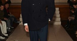 Sir Rod Stewart's son, Alastair Wallace, looked incredibly dapper in a navy coat with statement shoulder pads as he stormed the runway at Kent&Curwen's 100th anniversary show on Tuesday
