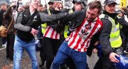 Sunderland fans spotted holding their heads after being struck by bottles thrown by Newcastle fans as supporters clash ahead of derby day