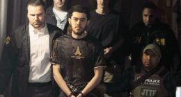 Ibrahim Kayumi (front) and Emir Balat (back) in federal custody leaving the NYPD's 26th Precinct stationhouse in Manhattan on Monday