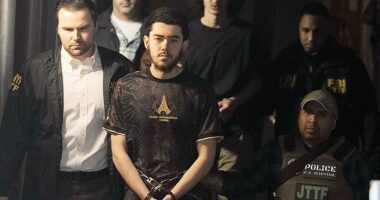 Ibrahim Kayumi (front) and Emir Balat (back) in federal custody leaving the NYPD's 26th Precinct stationhouse in Manhattan on Monday