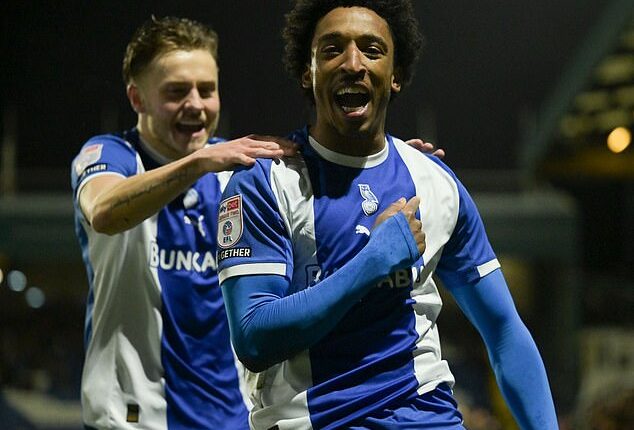 Oldham's Kane Drummond celebrates scoring his side's early goal against Notts County. The Latics ran out 3-0 winners and are flying towards the League Two play-offs