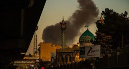 Smoke rises over Tehran on Friday after reported after US strikes on the Iranian capital