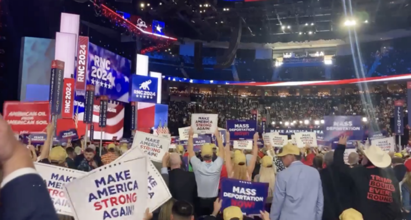 Attendees at RNC Convention hold 'Mass Deportations Now' signs