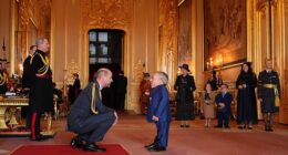 Warwick Davis was supported by a mystery woman as he accepted his OBE on Wednesday, after crediting a woman called 'Sponge' for 'helping him love again' following his wife's death