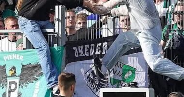 TV footage showed a person in white overalls and a ski mask in Munster green climbing back into the home fans' stand