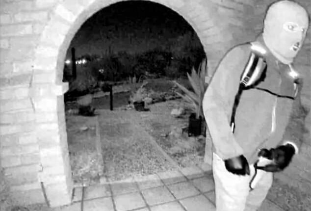 Picture provided by the FBI shows a masked man at the home of Nancy Guthrie the night she went missing in Tucson, Ariz