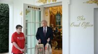 President Donald Trump holds McDonald's bags outside the Oval Office at the White House