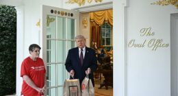 President Donald Trump holds McDonald's bags outside the Oval Office at the White House