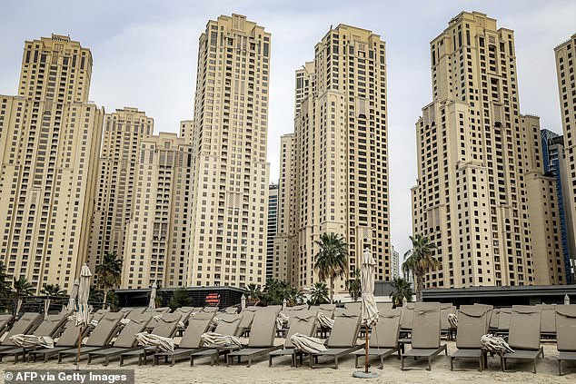 Empty sun loungers line a beach at Jumeirah Beach Residence, formerly a tourism hotspot