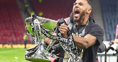 Ayunga celebrates with the Premier Sports trophy that he helped fire Saints to last year