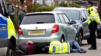 Police check the engine and undercarriage of a silver-coloured Skoda in a road in Finchley last Friday