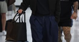 Celeste Barber cut an uncharacteristically downcast figure as she arrived at Sydney Airport on Wednesday, two months after her split from husband Api Robin