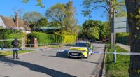 Police officers patrol a cordon set up outside the synagogue in the early hours of Sunday morning