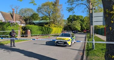Police officers patrol a cordon set up outside the synagogue in the early hours of Sunday morning