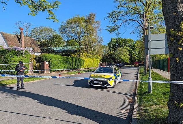 Police officers patrol a cordon set up outside the synagogue in the early hours of Sunday morning