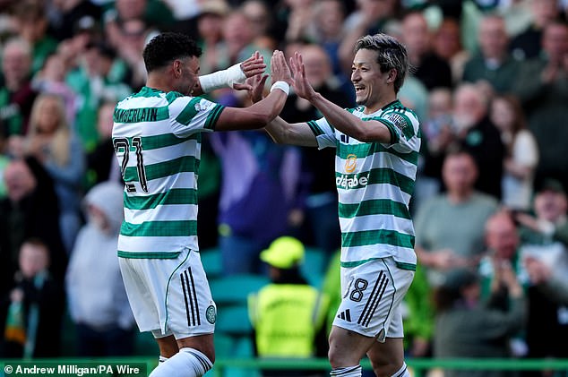 Daizen Maeda (right) celebrates with Celtic team-mate Alex Oxlade-Chamberlain