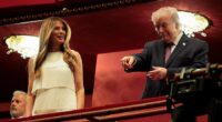 President Donald Trump (right) gesticulates at the audience alongside First Lady Melania Trump as the first couple attended the opening night of the musical Chicago at the newly renamed Trump Kennedy Center Tuesday night