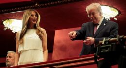 President Donald Trump (right) gesticulates at the audience alongside First Lady Melania Trump as the first couple attended the opening night of the musical Chicago at the newly renamed Trump Kennedy Center Tuesday night
