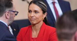 Director of National Intelligence Tulsi Gabbard stands after President Donald Trump spoke about the Iran war from the Cross Hall of the White House on Wednesday, April 1, 2026
