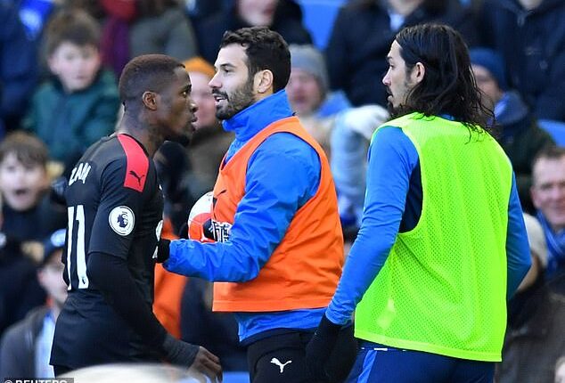Wilfried Zaha confronts Ezequiel Schelotto (right) during a heated clash in 2020
