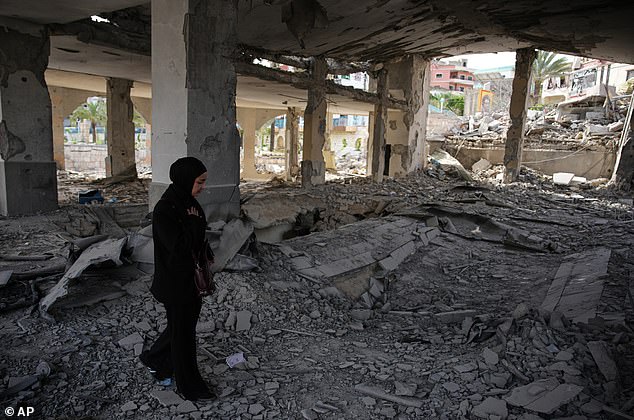 A local resident walks among debris inside a mosque destroyed in an Israeli airstrike in Jibchit, southern Lebanon, Friday, April 17, 2026, following a ceasefire between Israel and Hezbollah. (AP Photo/Hassan Ammar)