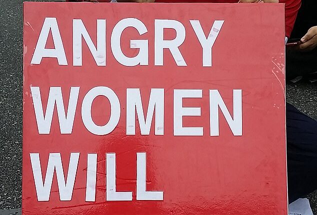 A South Korean woman in Seoul holding a placard which reads: "Angry women will change the world". South Korea has some of the most stark gender inequalities of any developed country