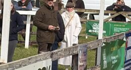 Geri Halliwell, dressed all in white, arrives at a point-to-point racing event at Edgcote with husband Christian Horner (to her left in brown cap)