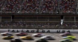 Cars race past the grandstands at Talladega Superspeedway during a NASCAR Cup Series event