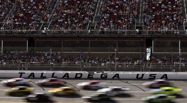 Cars race past the grandstands at Talladega Superspeedway during a NASCAR Cup Series event