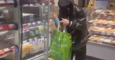 Greggs has scrapped front of store food and drink fridges in a new measure to tackle shoplifting - a thief is seen raiding near Norwood Junction in south London in November 2024