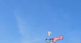 A parachutist was left dangling from the scoreboard after pre-game theatrics went wrong