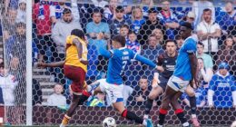 Emmanuel Longelo smashes home the late winner at Ibrox that has changed the title picture