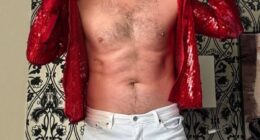 Jedward's John Grimes says trolls commenting on his weight gain amid TV comeback and comparing his physique to pop heyday 'hurts' as he strips off his shirt for empowering post: 'I can't wear skinny jeans 24/7'