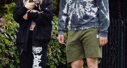 Joe Manganiello and his girlfriend Caitlin O'Connor, 33, bundled up in rain gear to venture out for a walk during the storm that has been flooding Los Angeles