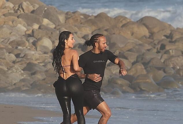 Kim Kardashian was seen making out with Lewis Hamilton for the first time as they were spotted at a beach in Malibu on Tuesday