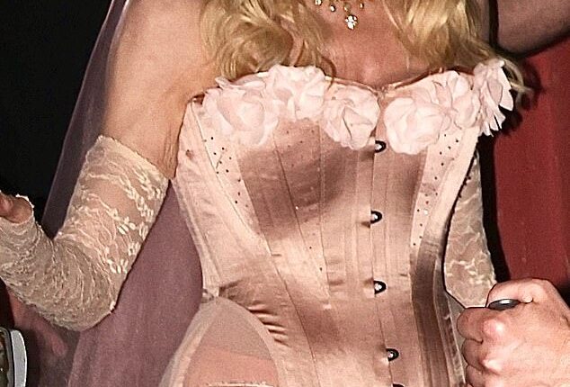 Madonna turned heads in a pink corset and lace veil as she left her Confessions II album release party in West Hollywood on Saturday night