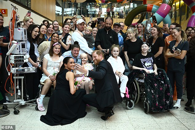 Meghan and Harry pose for a selfie with patients at the Royal Children's Hospital in Melbourne on day one of their Australian visit