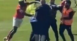 York City midfielder Hiram Boateng was seen striking out at a Rochdale fan amid a pitch invasion in an apparent retaliation after being pushed to the ground